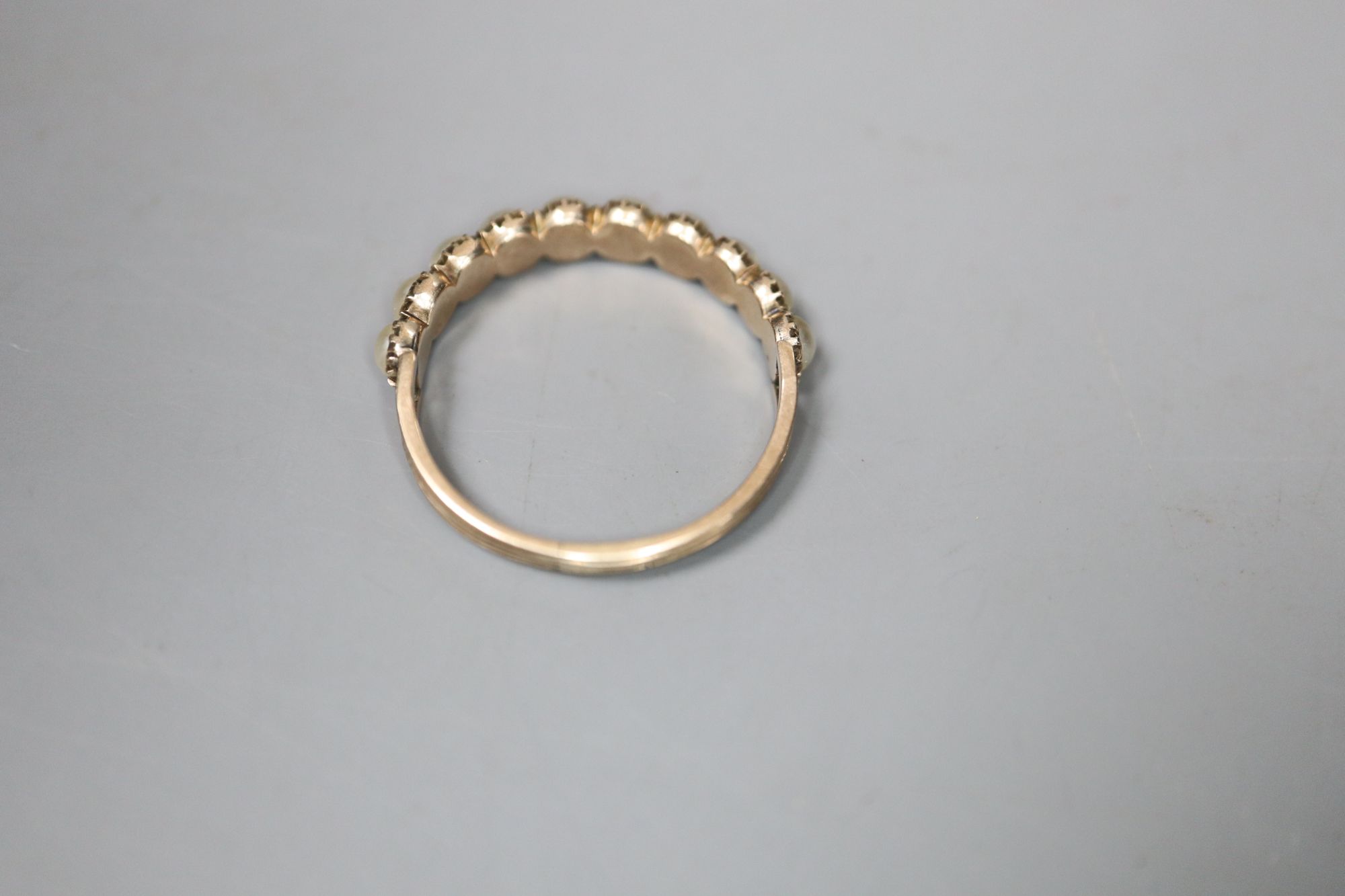 A 19th century gold and split pearl half hoop ring, set with ten pearls, gross 1.6 grams, size O/P.